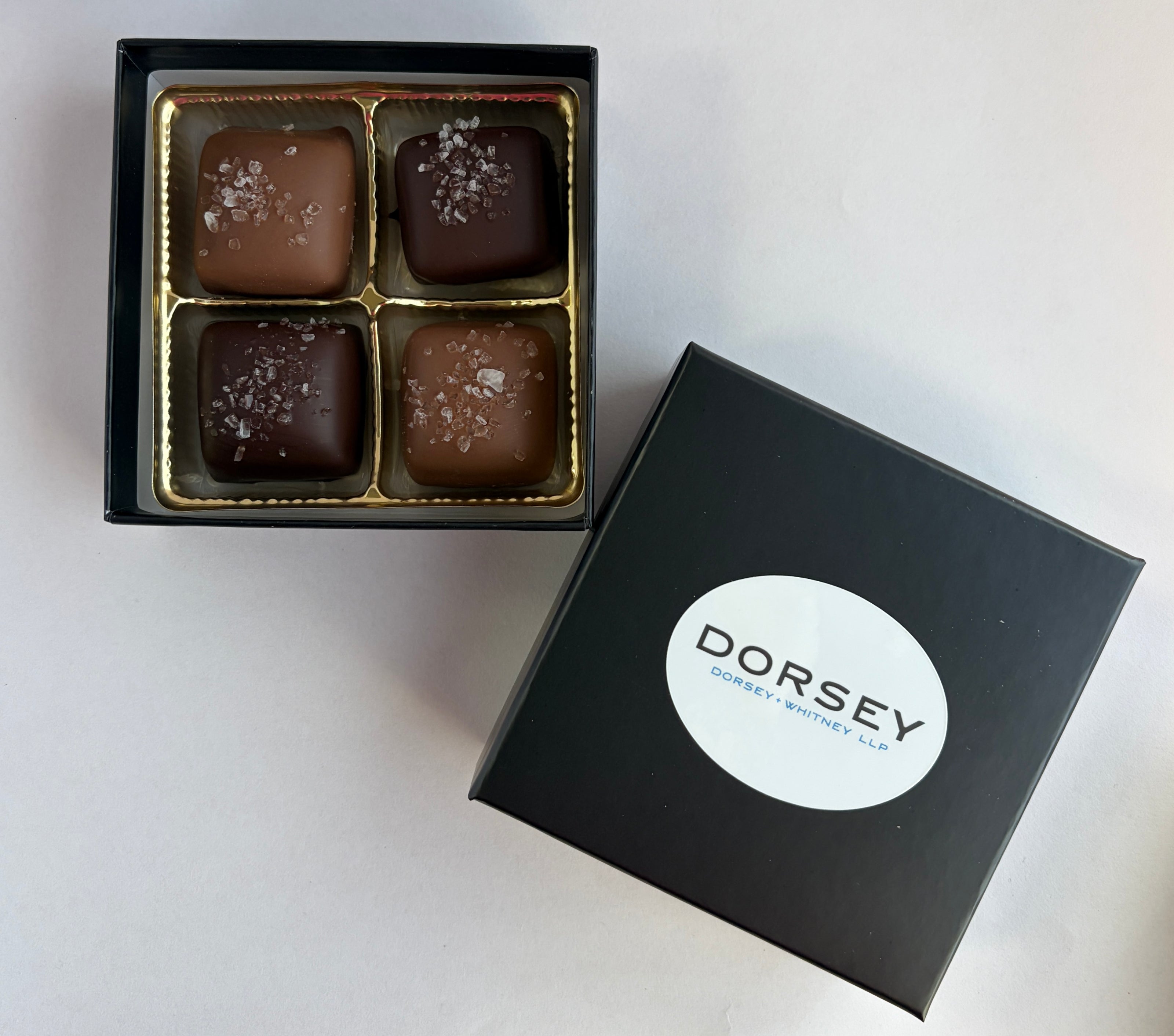 Handmade Sea Salt Caramel Chocolates in  a custom box wit a company logo.