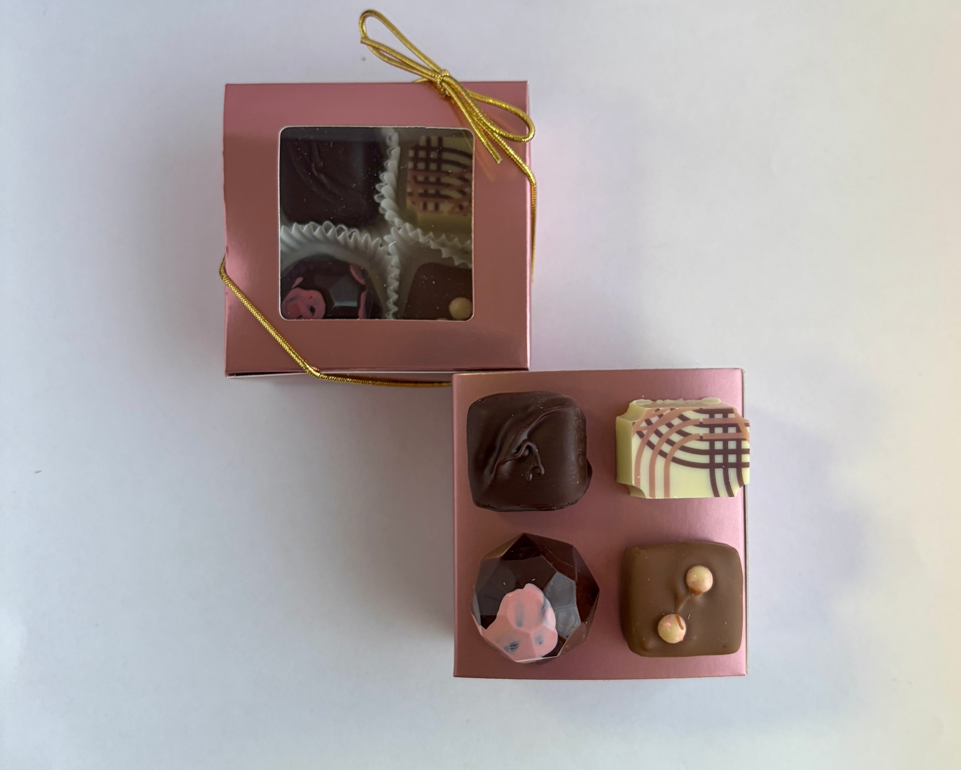 Two custom chocolate boxes that matched the event theme colors,  4 custom chocolates that matched the gala theme with one custom graphic based on the event invitation.